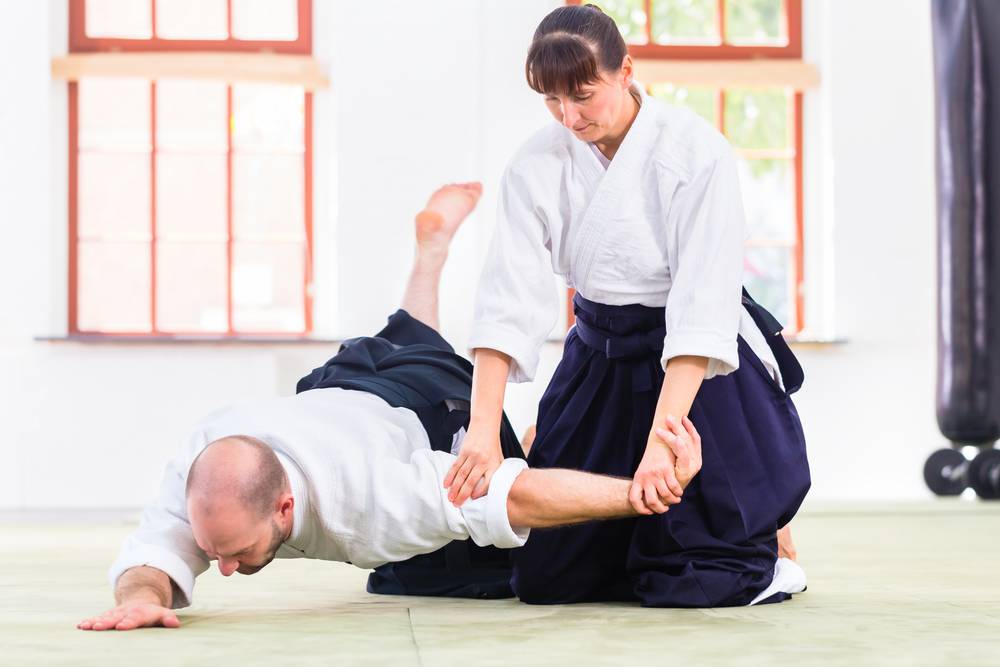 man and woman training aikido