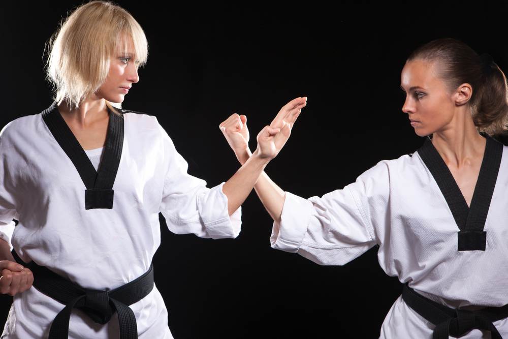 two taekwondo ladies who facing each other