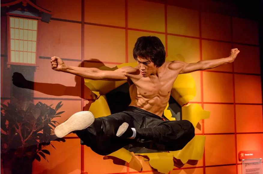 bruce lee with a flying kick