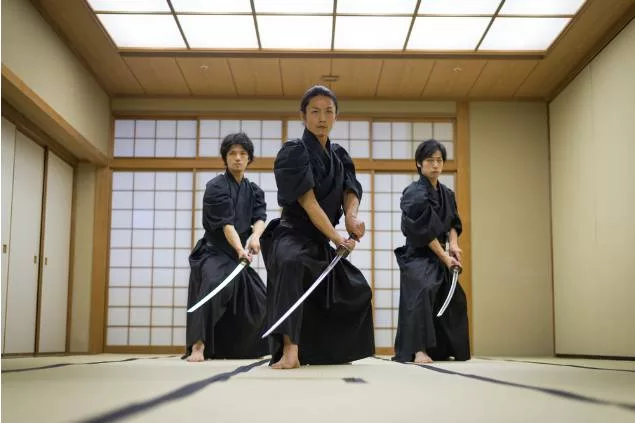 japanese martial artists holding swords